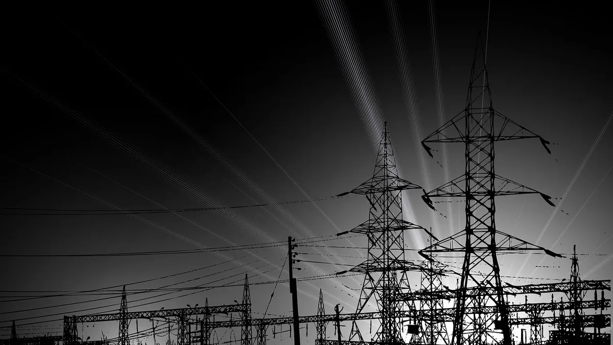 A large electrical substation with multiple power lines and transmission towers.